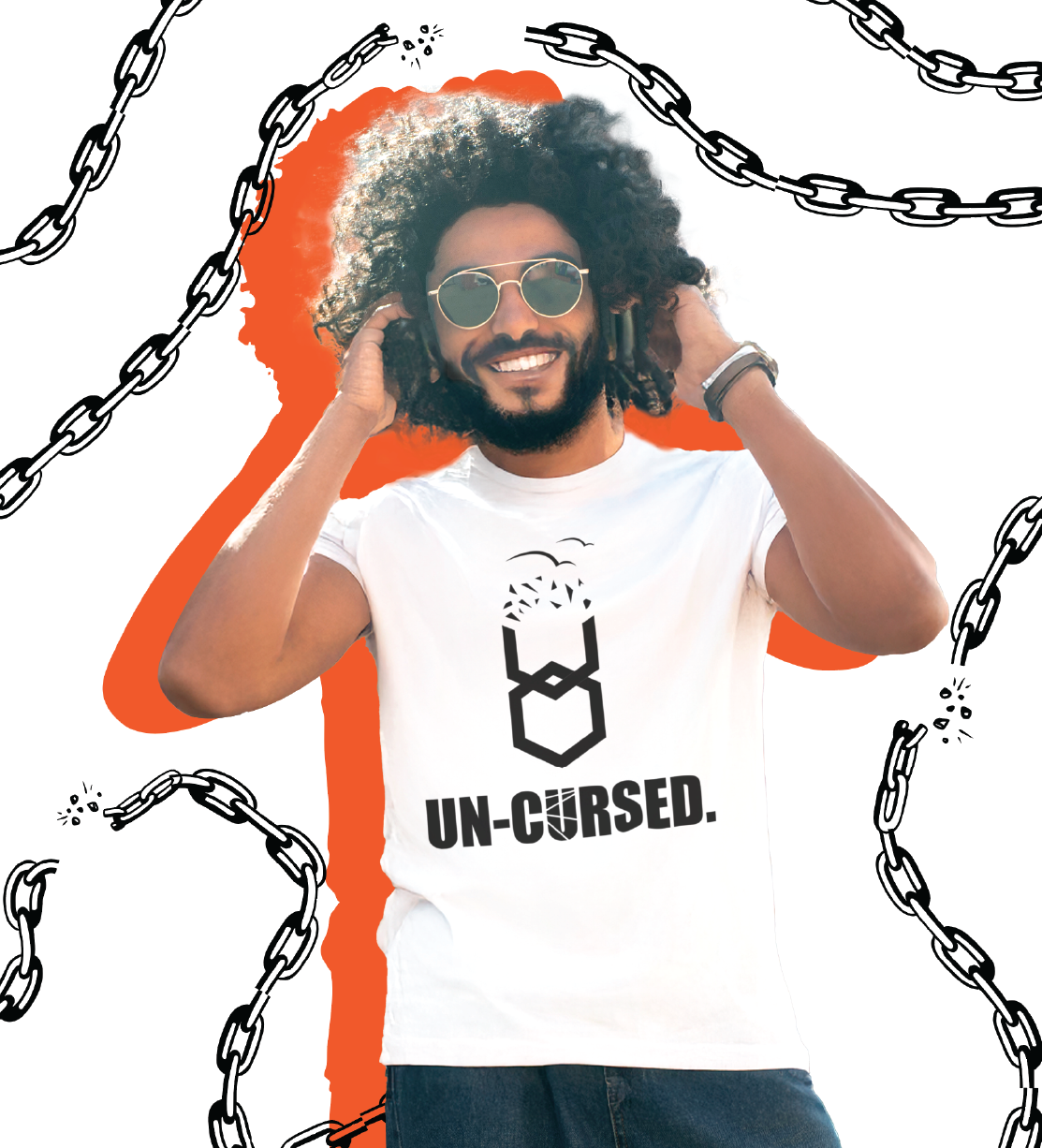 Man wearing a white t-shirt with 'UN-CURSED.' text and design, surrounded by chains.